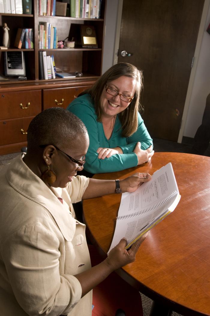 A community health worker helping a patient understand care and health information