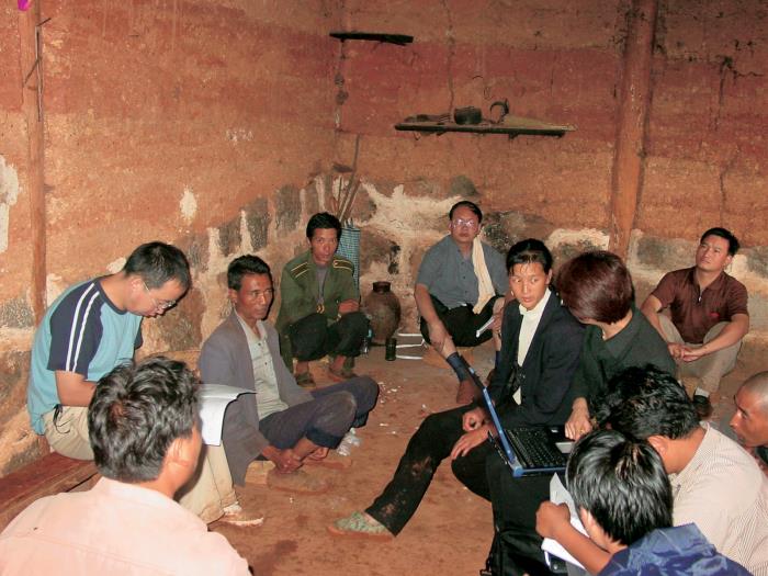 Field health professionals meeting with a local community